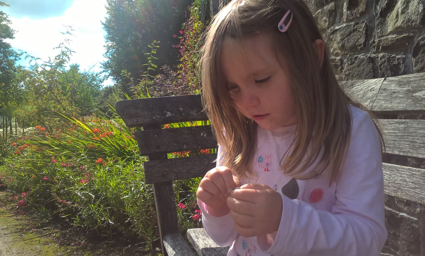 Kya carefully lining up acorns at the playground